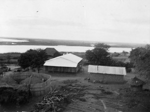 View of a mission station : Church thatched, house and kitchen