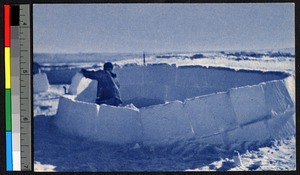 Man building an igloo, Canada, ca.1920-1940