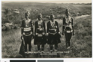 Four African women in beaded dresses, Africa