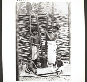 Two women pounding rice