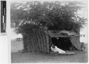 Hawaiian woman and her home, Hawaii, ca. 1920-1940