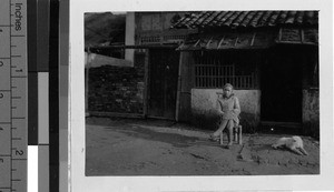 Man seated in a chair, Guilin, China, 1948