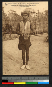 Musician standing with instrument in hand, Congo, ca.1920-1940