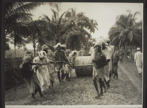 Road roller drawn by men