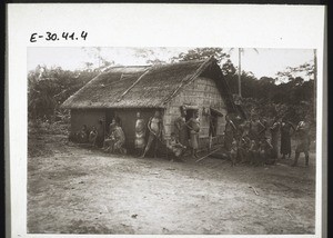 Africans outside a hut in the Lungasi region