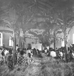 Church in Hayaland, Tanganyika (from 1964 Tanzania). The congregation is sitting on the grass c