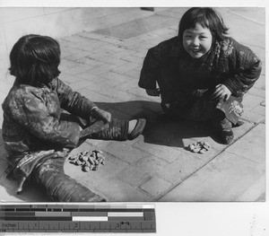 Two girls playing with stones at Fushun, China, 1938