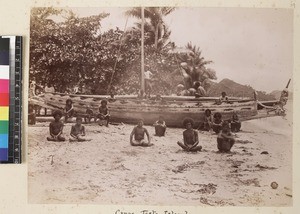 Men seated on shore with canoe, Wari Island, Papua New Guinea, ca. 1890