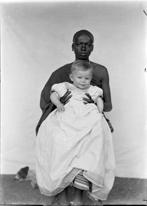 African woman with European child on her lap, Tanzania, ca.1893-1920