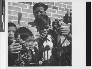 Boys playing with Tinkertoys at Wuzhou, China, 1950