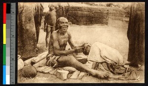 Man cutting hair in Yoruba area, Nigeria, ca.1920-1940