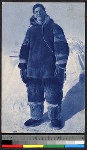 Missionary father standing outdoors in a thick fur suit, Canada, ca.1920-1940