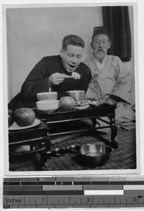 Father George Carroll, MM, eating a meal, Masan, Korea, ca. 1930-1950