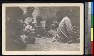 Women seated indoors with children, preparing food, Jiangsu, China, ca.1905-1910