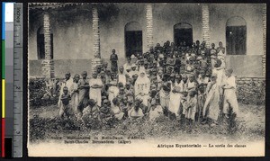 Missionary sister poses with a large group of students, Algeria, ca.1900-1930