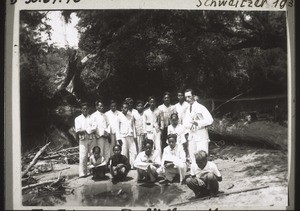 Baptism on the Boelik River, with the baptismal candidates sitting down (in Marambang)