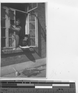 Maryknoll Sister window washing at Fushun , China, 1932