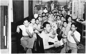 Sr. Frederica, MM, with group of boys enjoying a meal at St. Paul's Hospital, Manila, Philippines, March 1, 1939