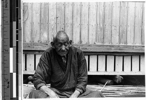 Elderly Japanese man sitting with his eyes closed, Japan, ca. 1947