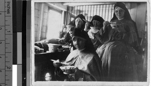 Maryknoll Sisters eating while traveling by riverboat, Kaying, China, ca. 1940