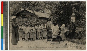 Missionary fathers and harpsichordist teaching children to sing, Tanganyika, ca.1920-1940