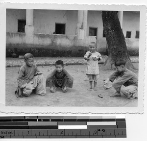 Children playing marbles in Soule, China, 1935