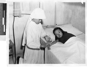 Sister caring for patient, Toishan, China, ca. 1948