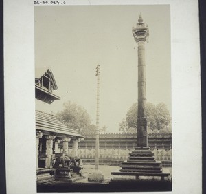 Dchaintempelchen auf einer Steinsäule in Mudabidri. Indien. Grosser Dschaintempel und Stange aus Kupfer zum Aufziehen von Götzen