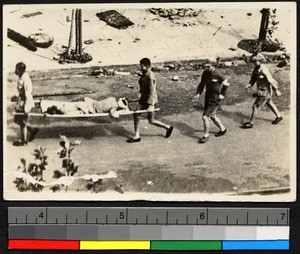 Men carrying a wounded soldier to the hospital, Shanghai, Shanghai Shi, China, 1937