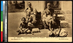 Boys and a man with a statue of Ganesha, India, ca.1920-1940