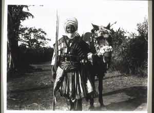 Cameroon, Grassfields. A brother of King Njoya. His horse with festive harness. He himself is wearing **