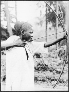 Boy shooting with bows and arrows, Tanzania, ca. 1927-1938