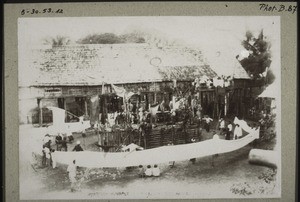 Funeral celebration." The men dance around the paddock in which the pigs and buffalo are kept