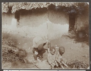 Three children at a stream, Tanzania