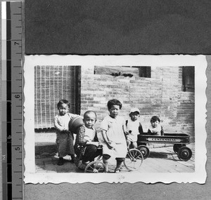 Children with tricycle, wagon and ball, Fenyang, Shanxi, China, ca.1936-37