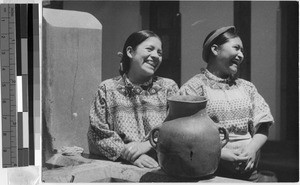 Two smiling women with a clay jug, Guatemala, ca. 1950