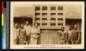 Missionary and men with large book cabinet, Cameroon, ca.1920-1940