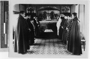 Men and boys gathered in front of an altar in the Trappist novitiate, Hakodate, Japan, ca. 1920-1940