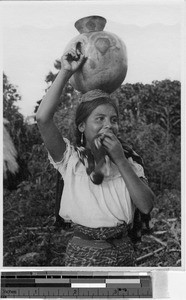 Girl carrying a clay jug on her head, Guatemala, ca. 1946