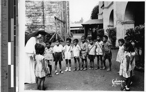 Sr. Beata, MM, with a group of children, Malabon, Philippines, 1948