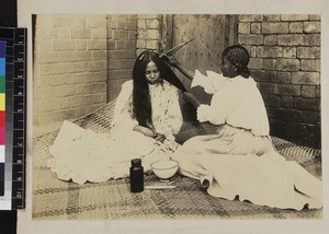 Women dressing hair, Madagascar, ca. 1900