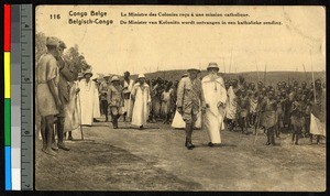 Colonial minister walking with missionary father amid a public gathering, Congo, ca.1920-1940