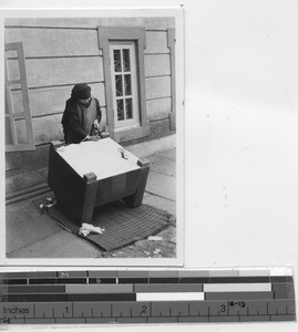 Sr. Pauline upholsters chair for Bishop's house at Jiangmen, China, 1947