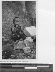 A small boy in the rocks at Hong Kong, China, 1935