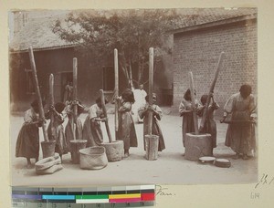 Girls from Antsahamanitra Girls' School thrashing rice, Antananarivo, Madagascar, 1901