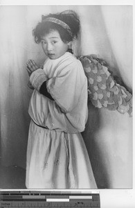 A young girl dressed as an angel at Fushun, China, 1940