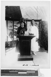 Korean couple standing behind a podium, Korea, ca. 1920-1940