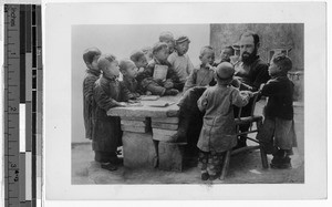 European clergyman reading to a group of Chinese children, China, ca. 1910-1930