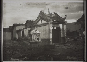 Market deity in the market at Moihang. On the left a little tower for the receipt of paper on which signs have been written, and on which no Chinese may tread, out of reverence for the signs