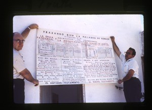 two men holding a chart used in preaching and teaching